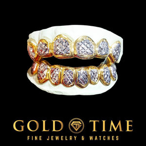 Full top and bottom 12 piece two-tone grill with diamond dust faces in rose toned gold frames, shown on a dental mold