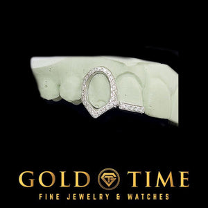 Iced open face fang cap joined to a moissanite tipped incisor cap, fitted to a dental mold
