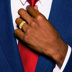 Man in a navy suit and red tie wearing the gold nugget diamond ring