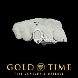 White gold open face canine fang cap with moissanite tip bar on a dental mold