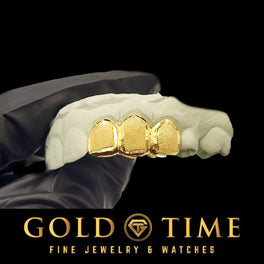 Gold grillz on a white hand with 'Gold Time' branding at the bottom.