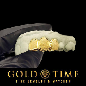Gold grillz on a white hand with 'Gold Time' branding at the bottom.