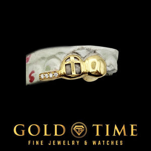 Close up of custom 3 piece cross cut-out grillz with moissanite tip