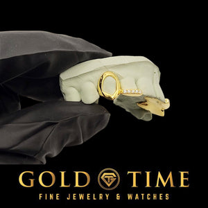 Open face fang grillz shown in gold plated silver