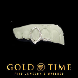 Angled view of the iced open face fang cap showing the moissanite set around the frame