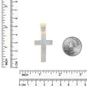 Diamond cross pendant next to a ruler and a quarter for size