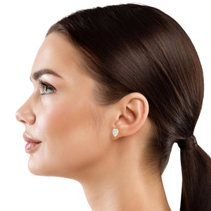 Petite diamond heart stud earring worn on the ear, shown in profile