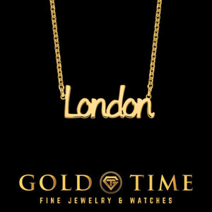 Yellow gold Daisy Dash script name necklace reading London on a matching cable chain, black background
