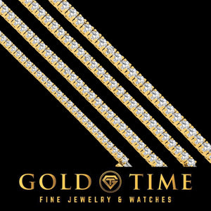 Three 14K gold diamond tennis bracelets laid diagonally on black