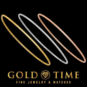 Three thin polished bangles in yellow, white, and rose gold, shown on black