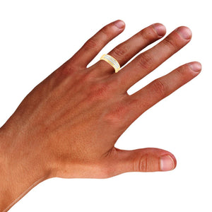 Yellow gold two row diamond band worn on a man's ring finger