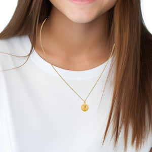 Woman wearing a 14K gold Sacred Heart Jesus medal on a chain