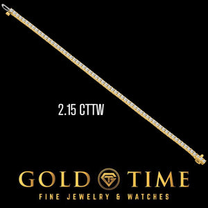 Yellow gold 2.15 cttw diamond tennis bracelet laid straight on black