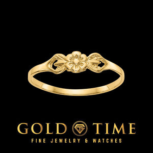 Yellow gold petite flower ring with leaf scrolls on each side of the flower, on black