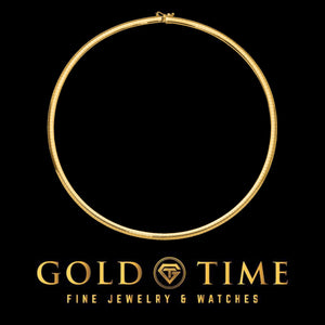 Slim yellow gold domed omega necklace laid in a circle