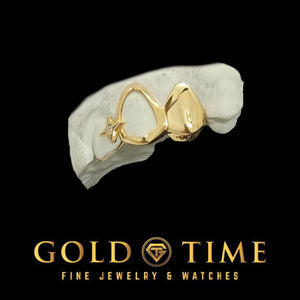 Angled view of the yellow gold open face cap with its moissanite star accent beside the polished solid cap