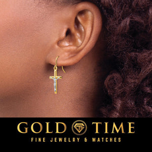 Two-tone crucifix earring worn on the ear