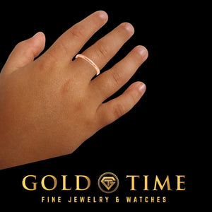 Rose gold baby band worn on a child's finger