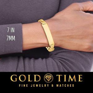 Wrist wearing a 7 inch 7mm yellow solid gold curb Cuban link ID bracelet