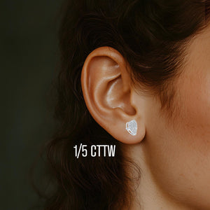 Pave diamond heart stud earring worn on the ear, labeled 1/5 cttw
