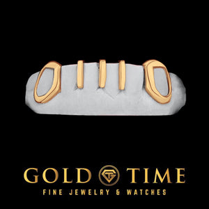 Yellow gold five piece grill with open face canines and three gap bars on a dental mold