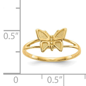Children's butterfly ring next to a ruler for size