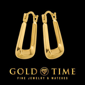 Pair of puffed yellow gold square hoops angled on a black Gold Time background