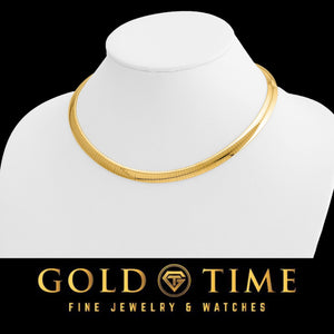 14K yellow gold domed omega necklace on a display bust