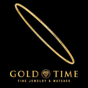 Yellow gold diamond-cut slip on bangle on black
