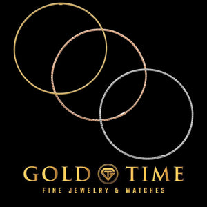 Three diamond-cut bangles in rose, yellow, and white gold laid in overlapping circles