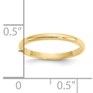 Yellow gold baby band next to a ruler for size