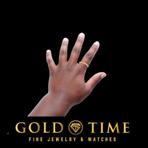Yellow gold baby band worn on a baby's finger