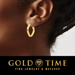 Yellow gold rounded square hoop earring worn on an ear