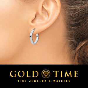 White gold rounded square hoop earring worn on an ear