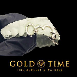 Side view of silver frameless open face grillz on a mold, showing how each outline hooks over the tooth