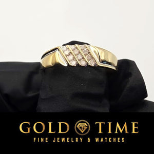 Close up of the diagonal diamond rows on the yellow gold band in a black gloved hand