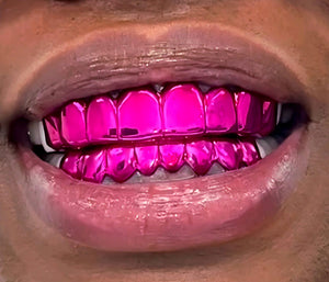 Smile wearing a top and bottom set of Neon Rose pink chrome grillz