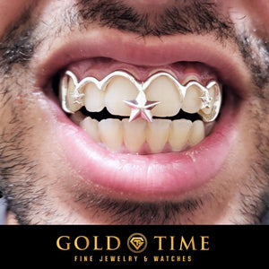 Smile wearing silver 6 piece frameless open face grillz with hooked outlines on each tooth and a 3D star between the front teeth