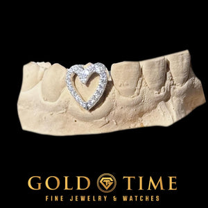 White iced heart single cap grillz, an open heart outline set with moissanite over one tooth, on a dental mold