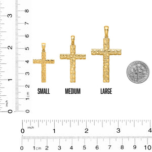 Small, medium, and large nugget crosses next to a ruler and a dime