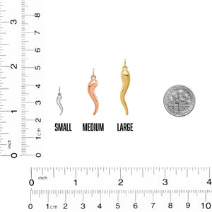 Small, medium, and large Italian horn charms beside a dime and ruler for size