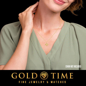 Woman wearing a yellow gold Mom heart charm on a necklace; chain not included