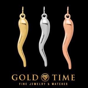 Three Italian horn charms in yellow, white, and rose gold, shown on black