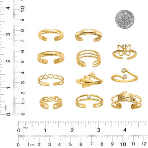 Twelve gold toe rings next to a ruler and a coin for scale