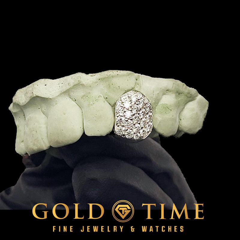 Close view of a white bustdown honeycomb moissanite single cap on a front tooth of a dental mold