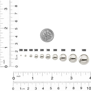 Sterling silver spacer beads from 2mm to 14mm next to a ruler and a dime