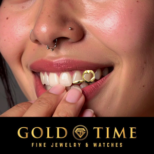 Smiling woman wearing the yellow gold heart cut-out double cap grill