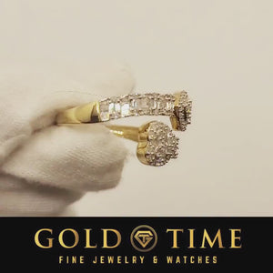 Gloved hand rotating a 10K gold diamond bypass heart ring to show the baguette set shanks