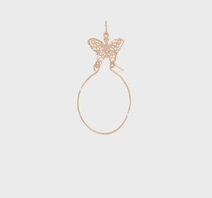 Video of the butterfly 14K gold charm holder pendant turning against a pale gray background