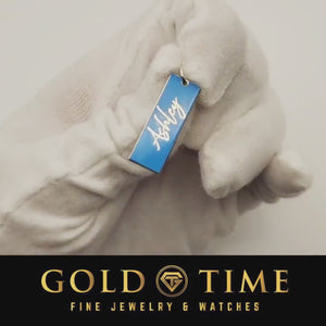 Product video of a blue enamel name charm with the name Ashley held in a gloved hand